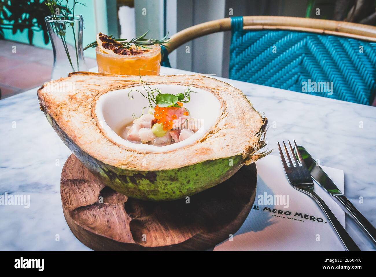 Hamachi and Coconut Ceviche Hamachi aguachile on a fresh, green coconut, hibiscus flower milk