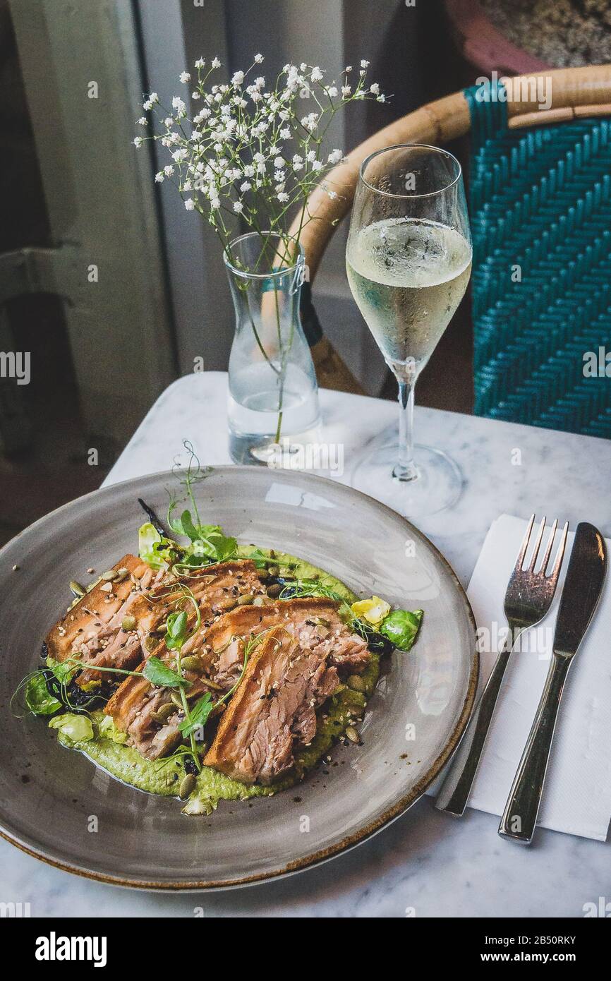 Pork Belly In Pipian Verde 14 hour slow cooked pork belly with crunchy skin, pumpkin seeds and green tomatillos salsa. Stock Photo