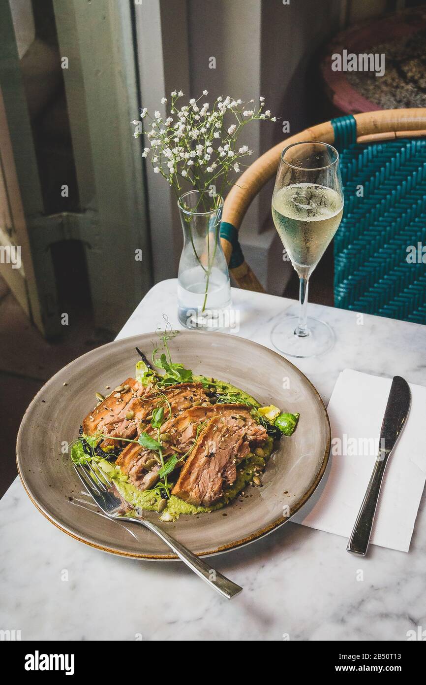Pork Belly In Pipian Verde 14 hour slow cooked pork belly with crunchy skin, pumpkin seeds and green tomatillos salsa. Stock Photo
