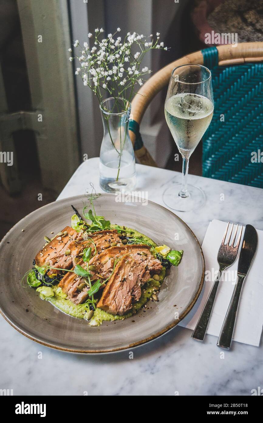 Pork Belly In Pipian Verde 14 hour slow cooked pork belly with crunchy skin, pumpkin seeds and green tomatillos salsa. Stock Photo