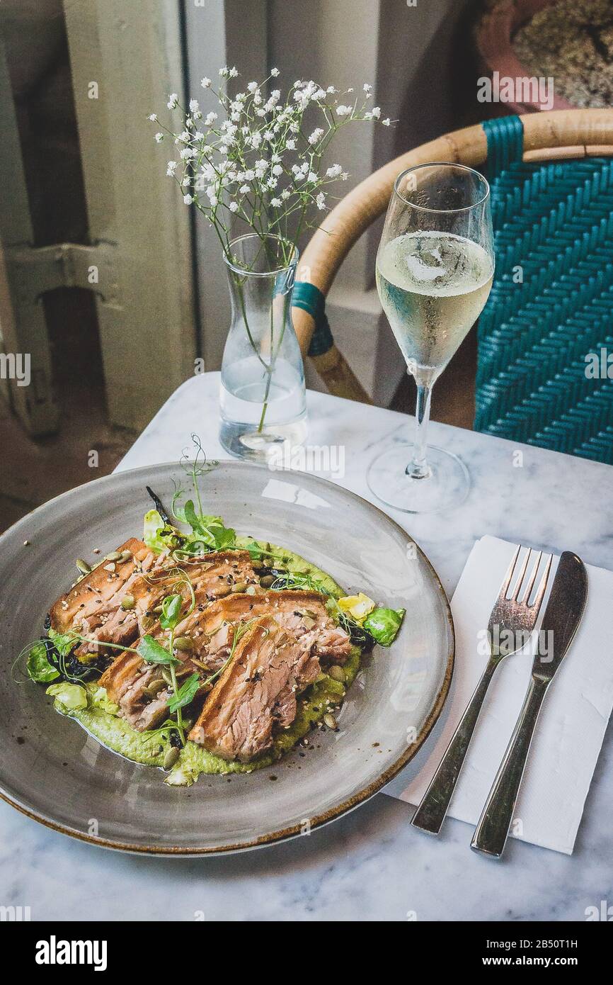Pork Belly In Pipian Verde 14 hour slow cooked pork belly with crunchy skin, pumpkin seeds and green tomatillos salsa. Stock Photo