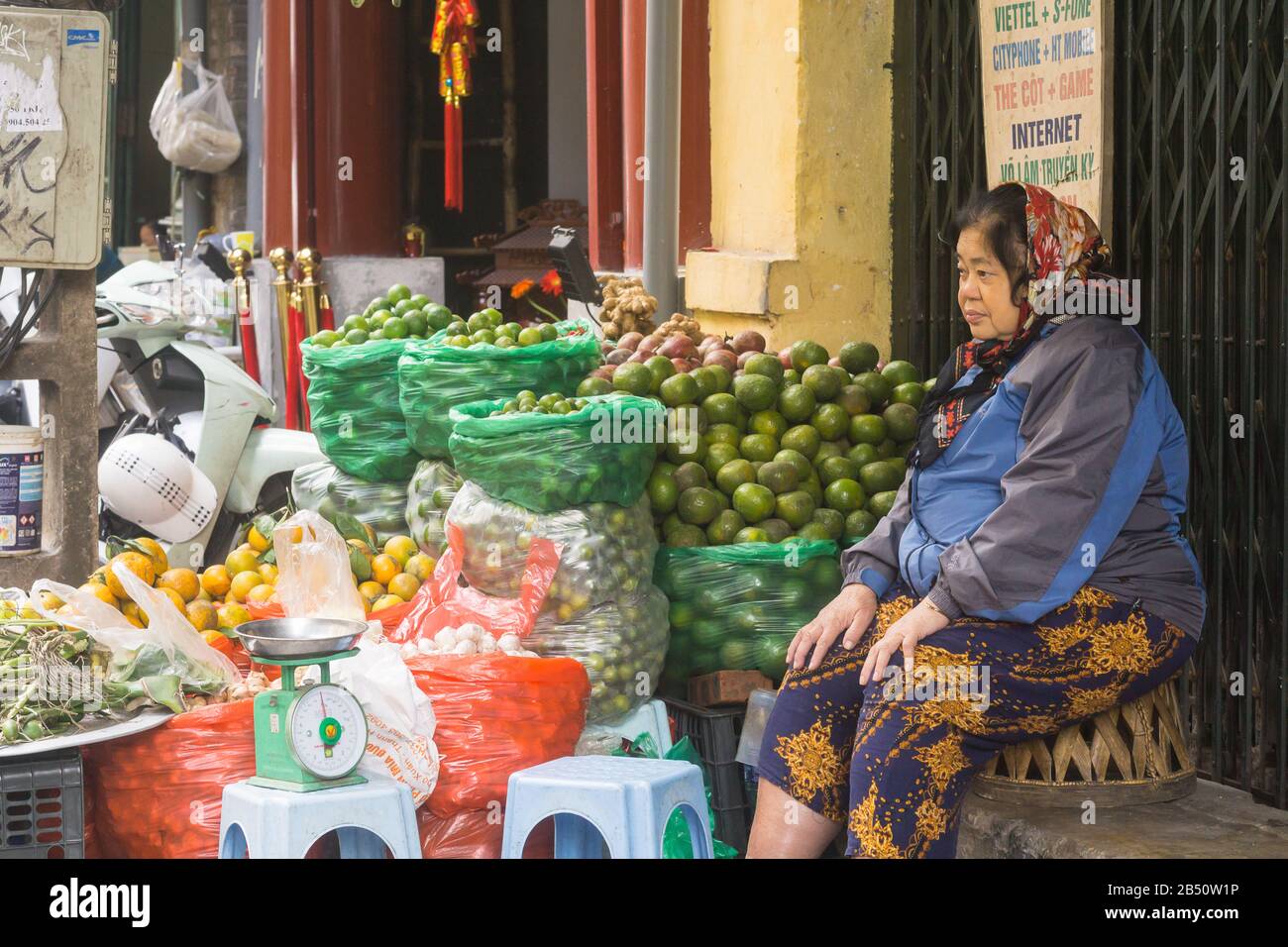 Vietnamese woman - An Elderly Vietnamese woman selling fresh produce on the street in Hanoi, Vietnam, Southeast Asia. Stock Photo