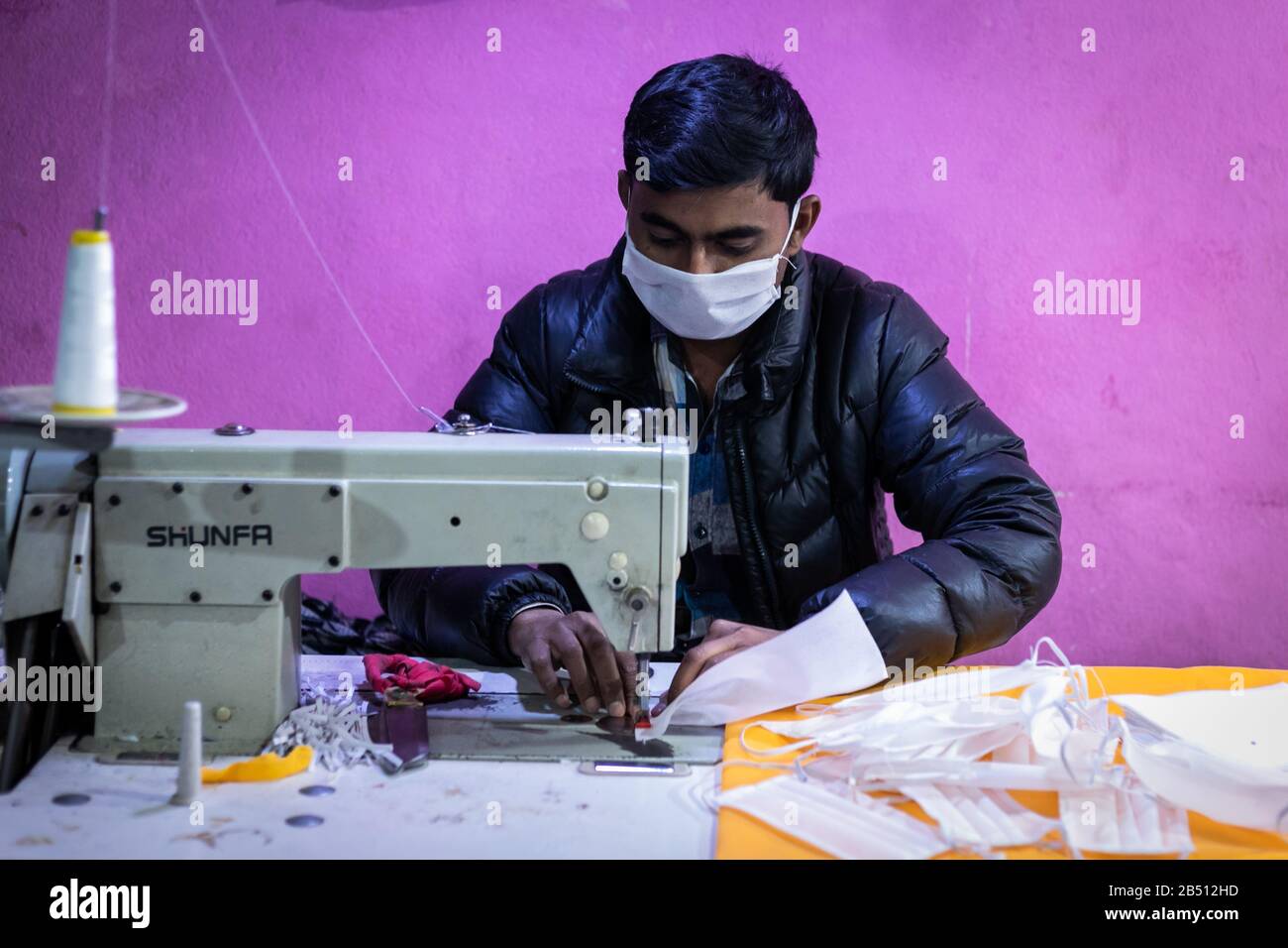 A factory worker making fabric face masks. Local factories are producing fabric mask to meet with demands as the COVID-19 coronavirus World Health Organisation (WHO) announced 98,192 people worldwide have been diagnosed with the corona virus (COVID-19) disease as of 6, March 2020. Stock Photo