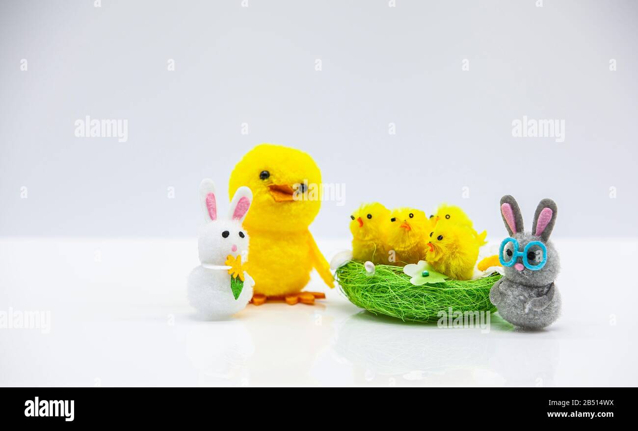 happy easter scene with yellow fluffy chicks in a basket  and bunnies Stock Photo