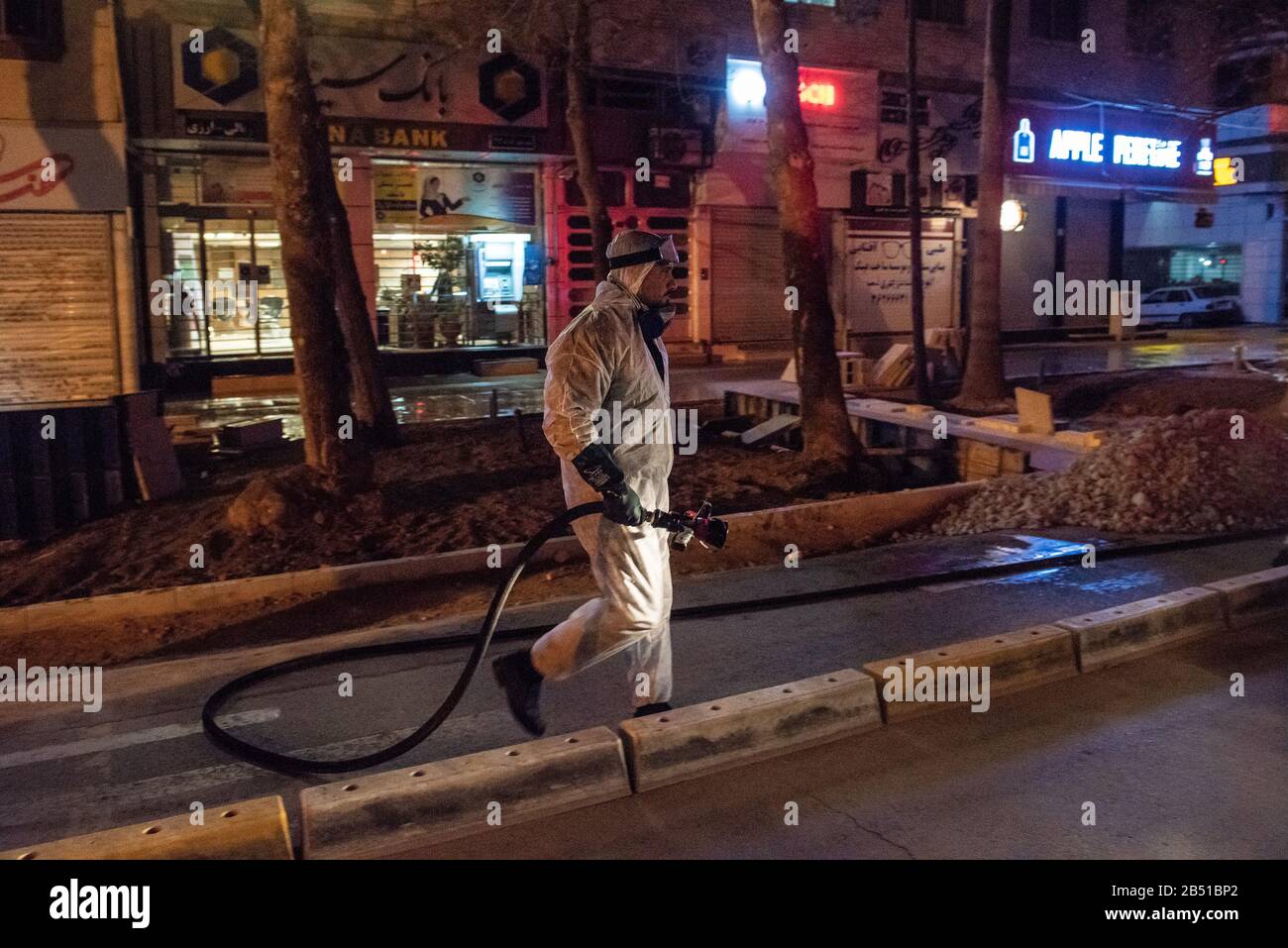 Disinfection of public places and thoroughfares in Shiraz, Afif-Abaad St. is underway with the aim of preventing and combating outbreak of Coronavirus(COVID-19). For this purpose, experts of health ministry have cooperated with the provincial fire department and disinfect the city in late hours of the night using machinery and mobile pumps. Iran, Fars province, Shiraz city. Stock Photo