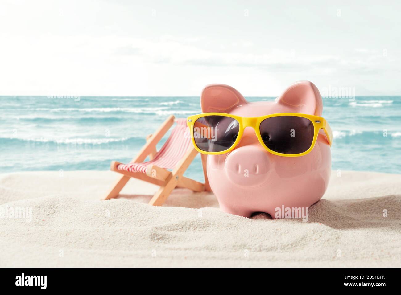 Piggy bank resting on vacation. Saving money, travel concept Stock Photo