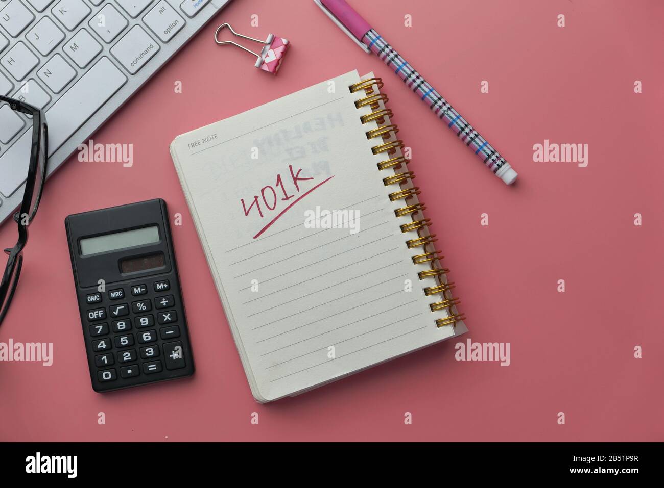401k text on notepad with coins and keyboard on table  Stock Photo