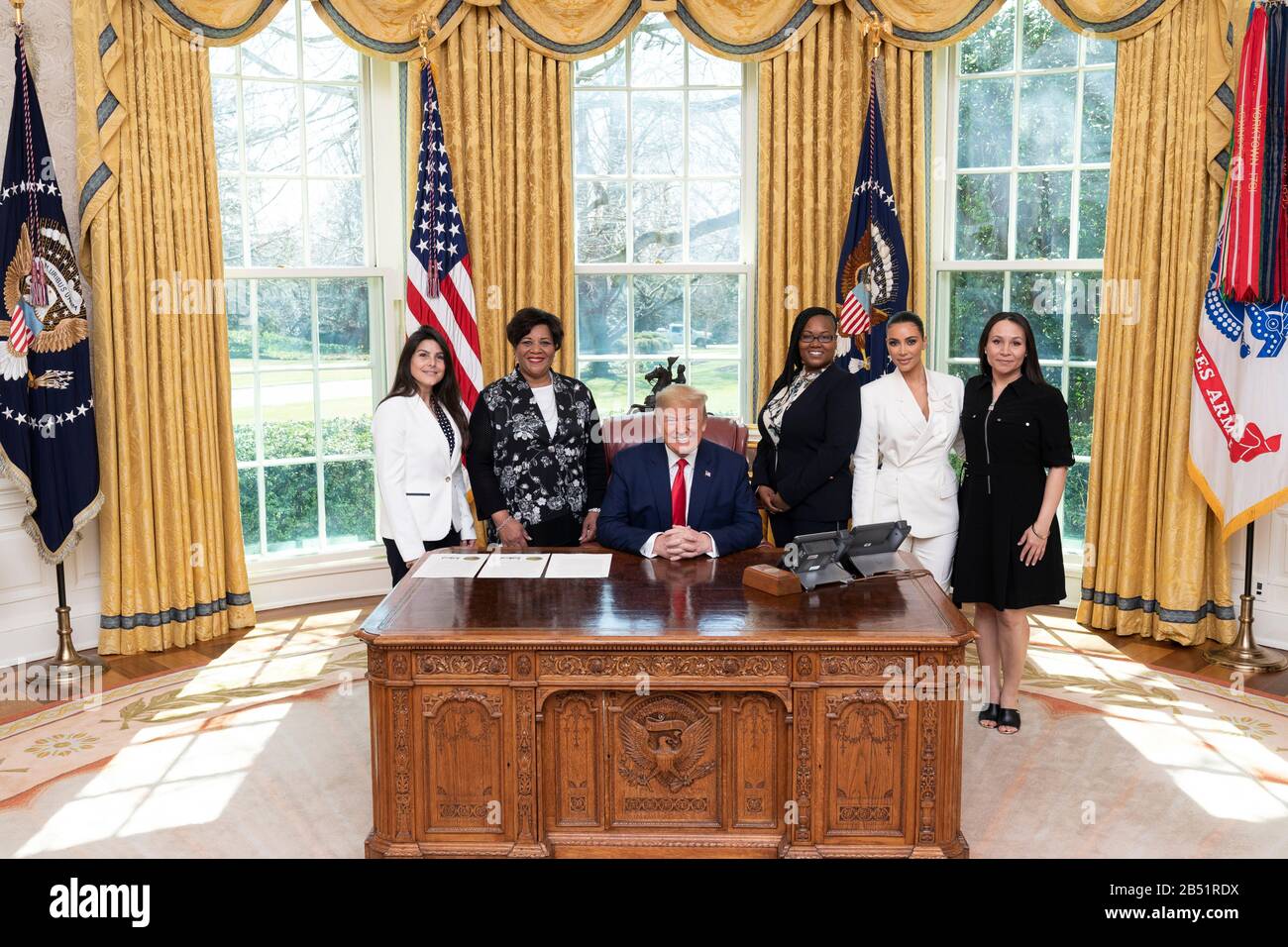 U.S President Donald Trump poses with former prisoners who had their sentences commuted in the Oval Office of the White House March 4, 2020 in Washington, DC. Standing left to right are: Judith Negron, Alice Johnson, Tynice Hall and celebrity Kim Kardashian and Crystal Munoz. Stock Photo