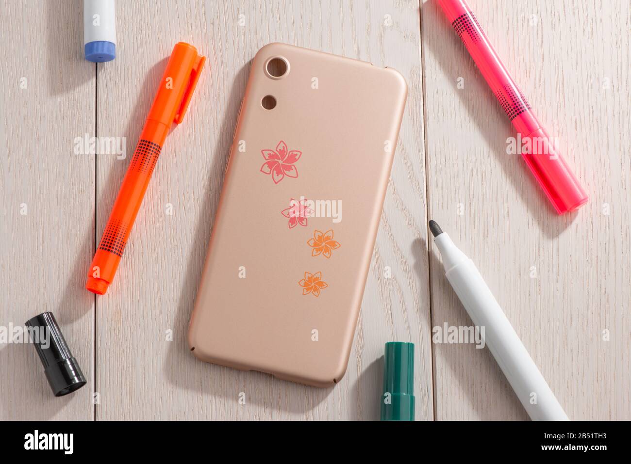 Flowers drawn on beige phone case, top view Stock Photo