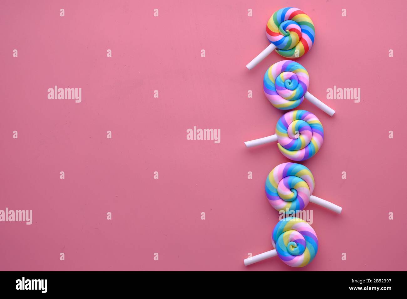 multi color lolly pop on pink background  Stock Photo