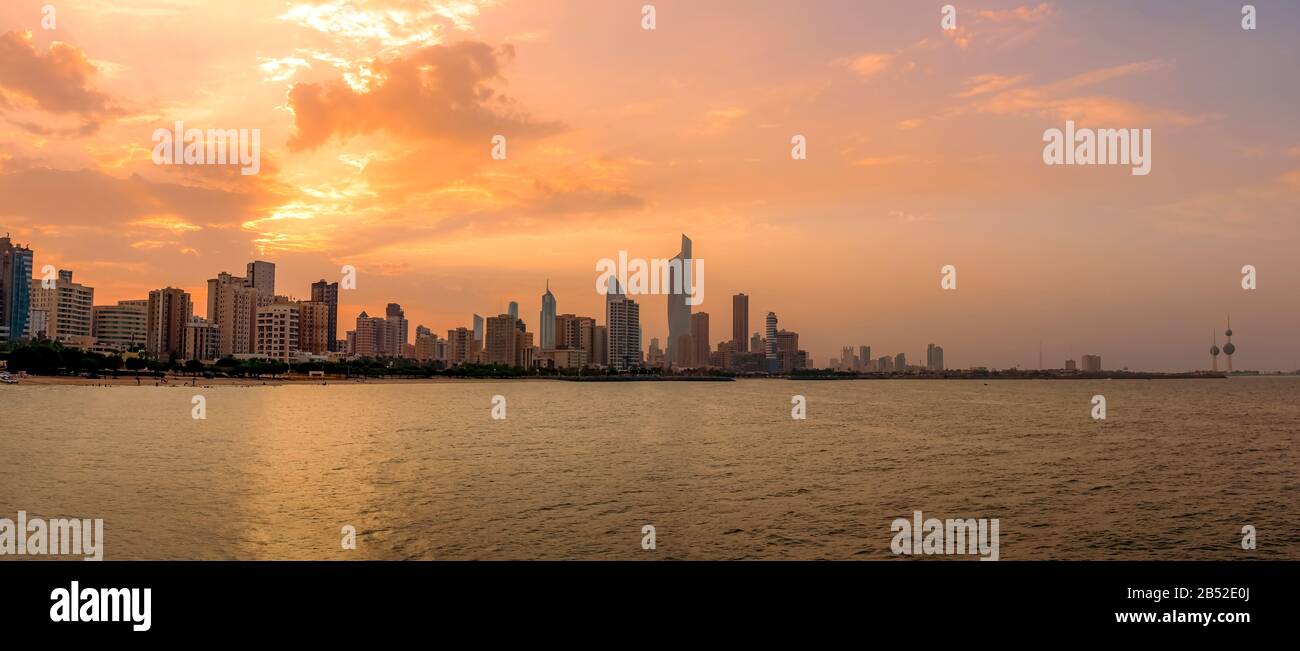 Panoramic View of Kuwait city Skyline from the Arabian Gulf Sea at Sunset Stock Photo