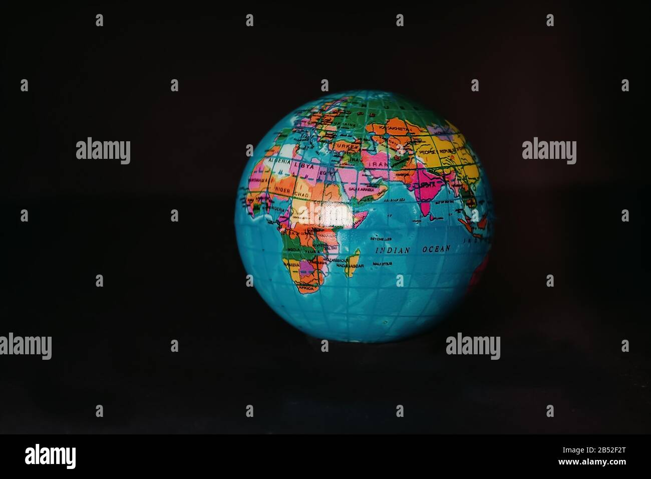 Multicolored globe isolated on a dark background. Stock Photo