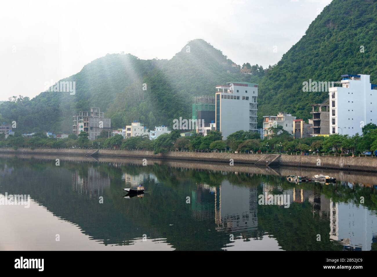 Cat Ba island, Vietnam Oct 17, 2019. Beautiful lake, reflection buildings in the water. Quiet district. foggy dawn Stock Photo