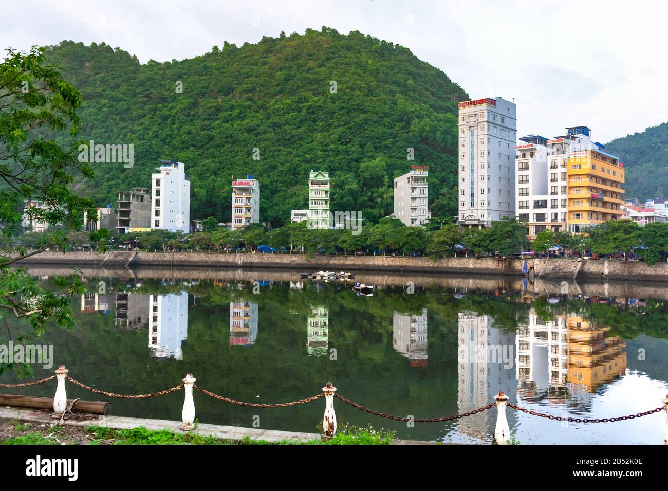 Cat Ba island, Vietnam Oct 17, 2019. Beautiful lake, reflection buildings in the water. Quiet district. Stock Photo