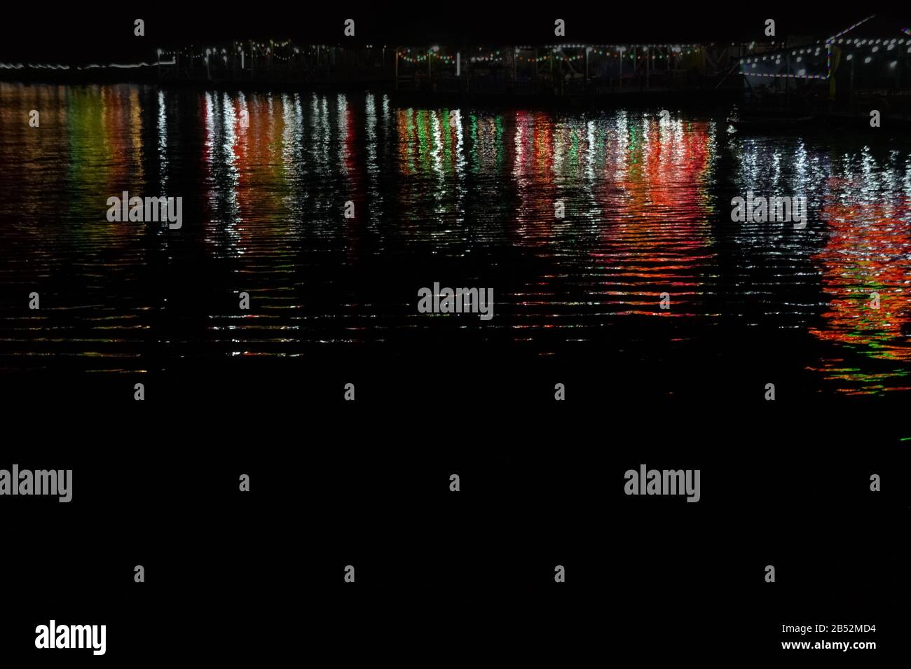 Water texture with color reflections on a black background Stock Photo