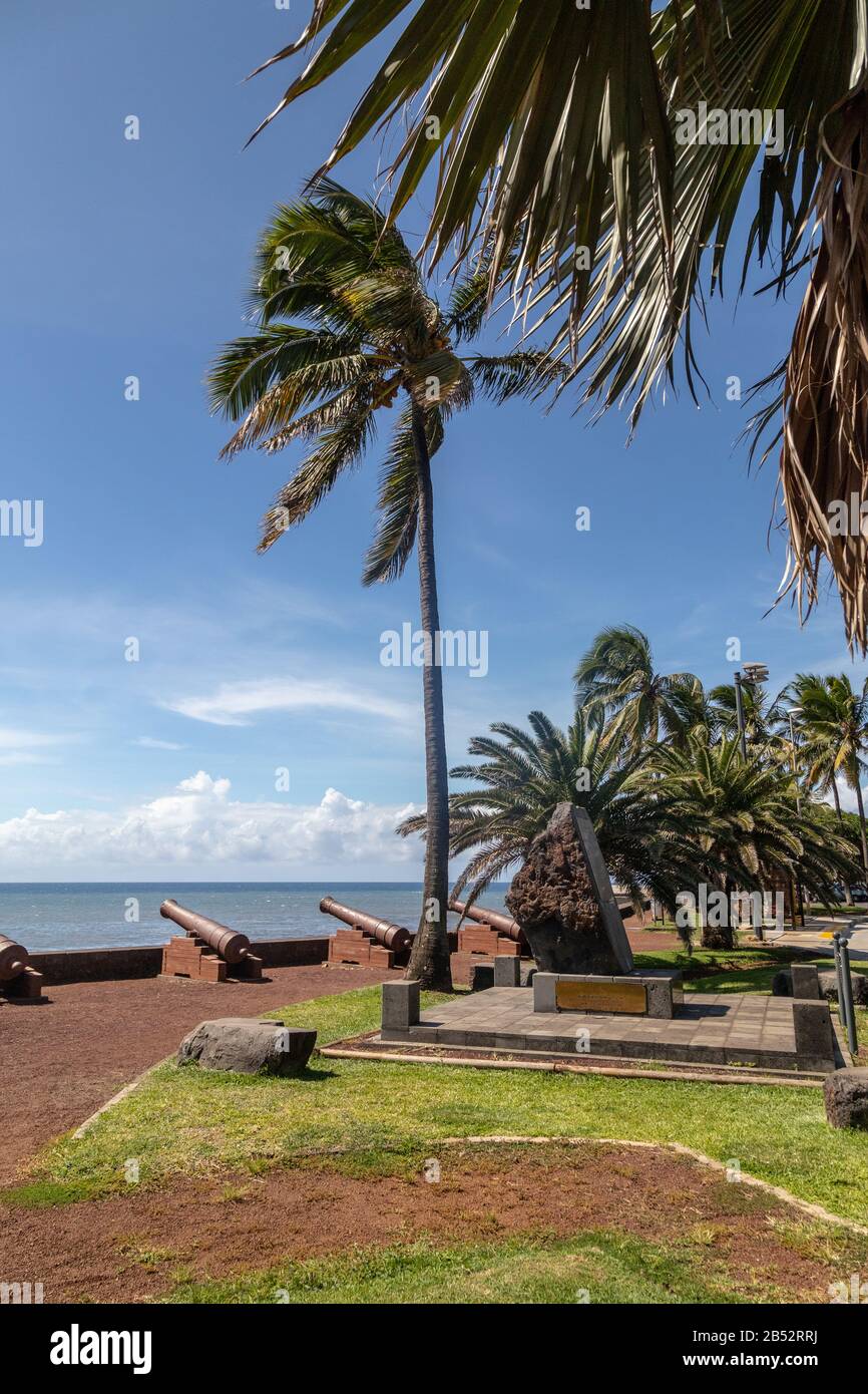 Old cannons and palm tree at the waterfront of Saint Denis on Reuinion island in the Indian Ocean Stock Photo