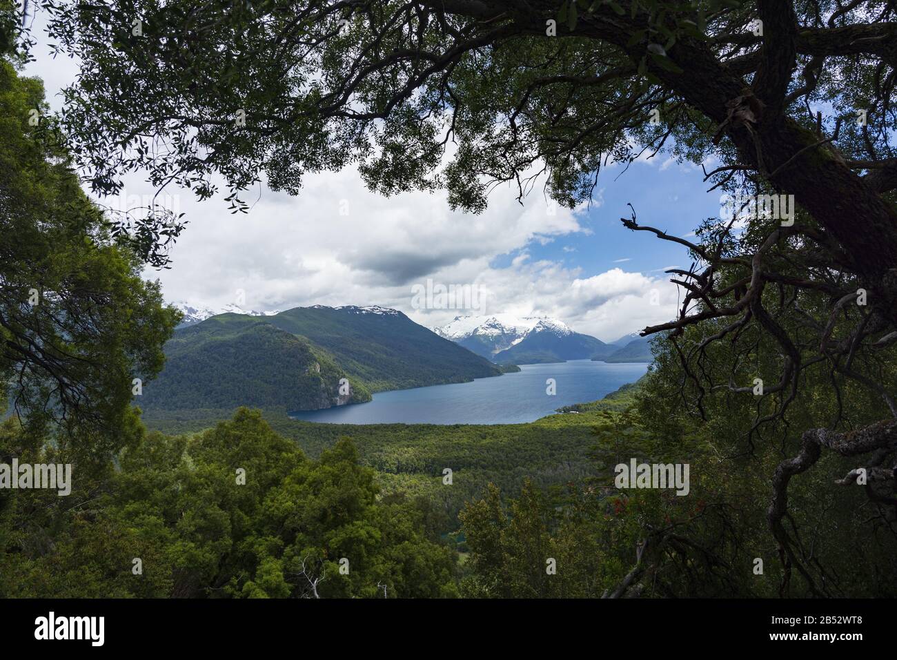 Lago Menendez nested between snowcapped mountains, Parque Nacional los Alerces, Patagonia Argentina Stock Photo