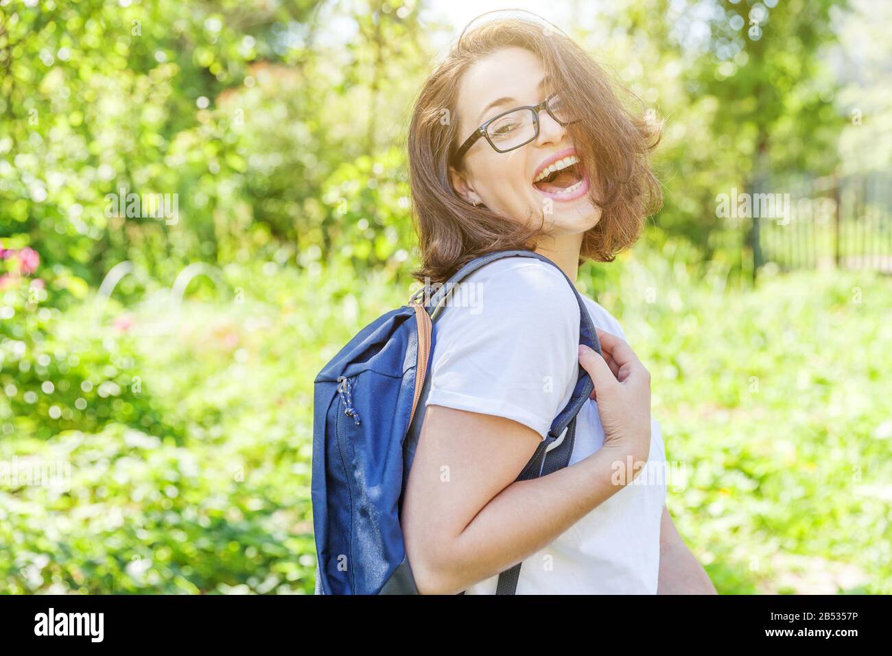 Positive Rested Students Happy beautiful positive student girl in eyeglasses with backpack ...