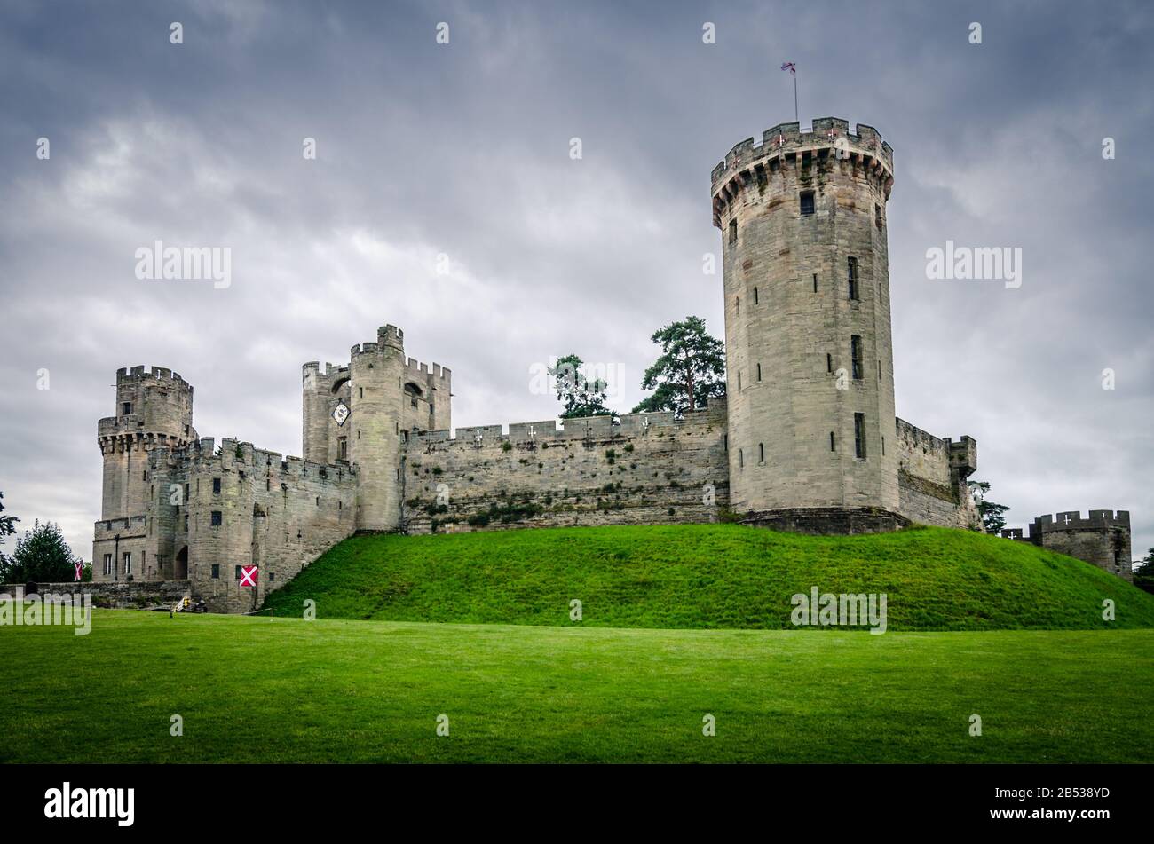 Dramatic view on the Warwick castle during cloudy day --- Warwick castle is a perfect one day trip from London. The castle ramparts can be climbed and Stock Photo