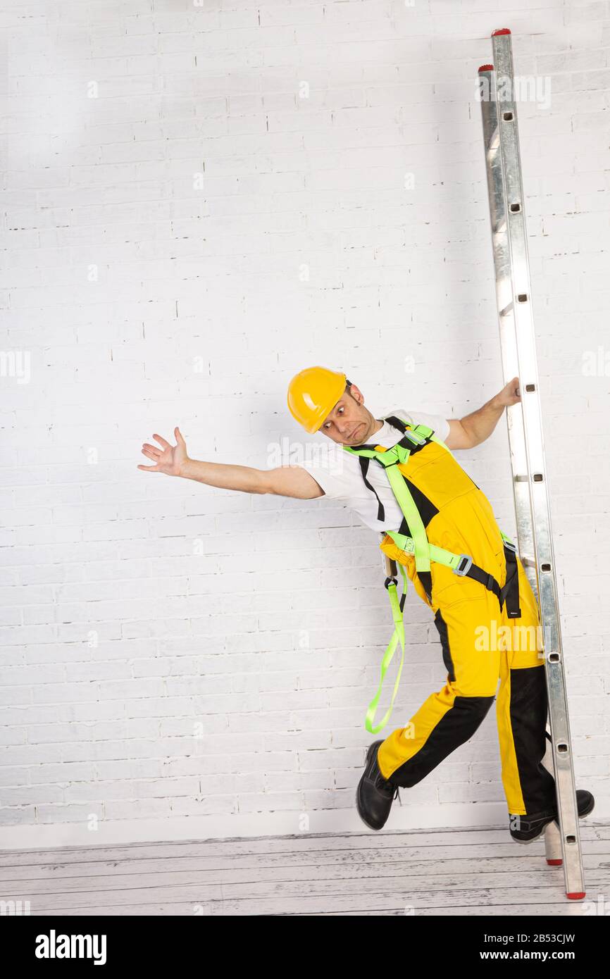 Irresponsible use of a ladder during construction work Stock Photo - Alamy