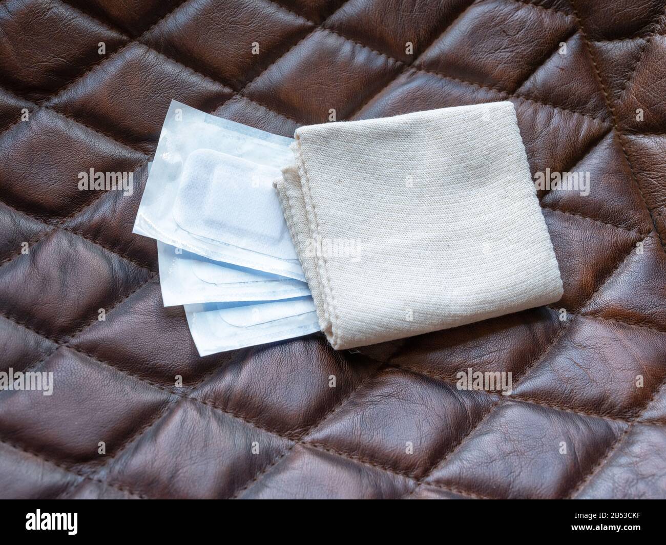 packaged gauze pads and bandage on brown background, concept of medecine Stock Photo