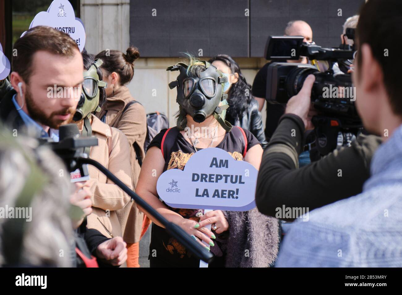 Bucharest, Romania March 4, 2020 Woman with a gas mask holds a sign