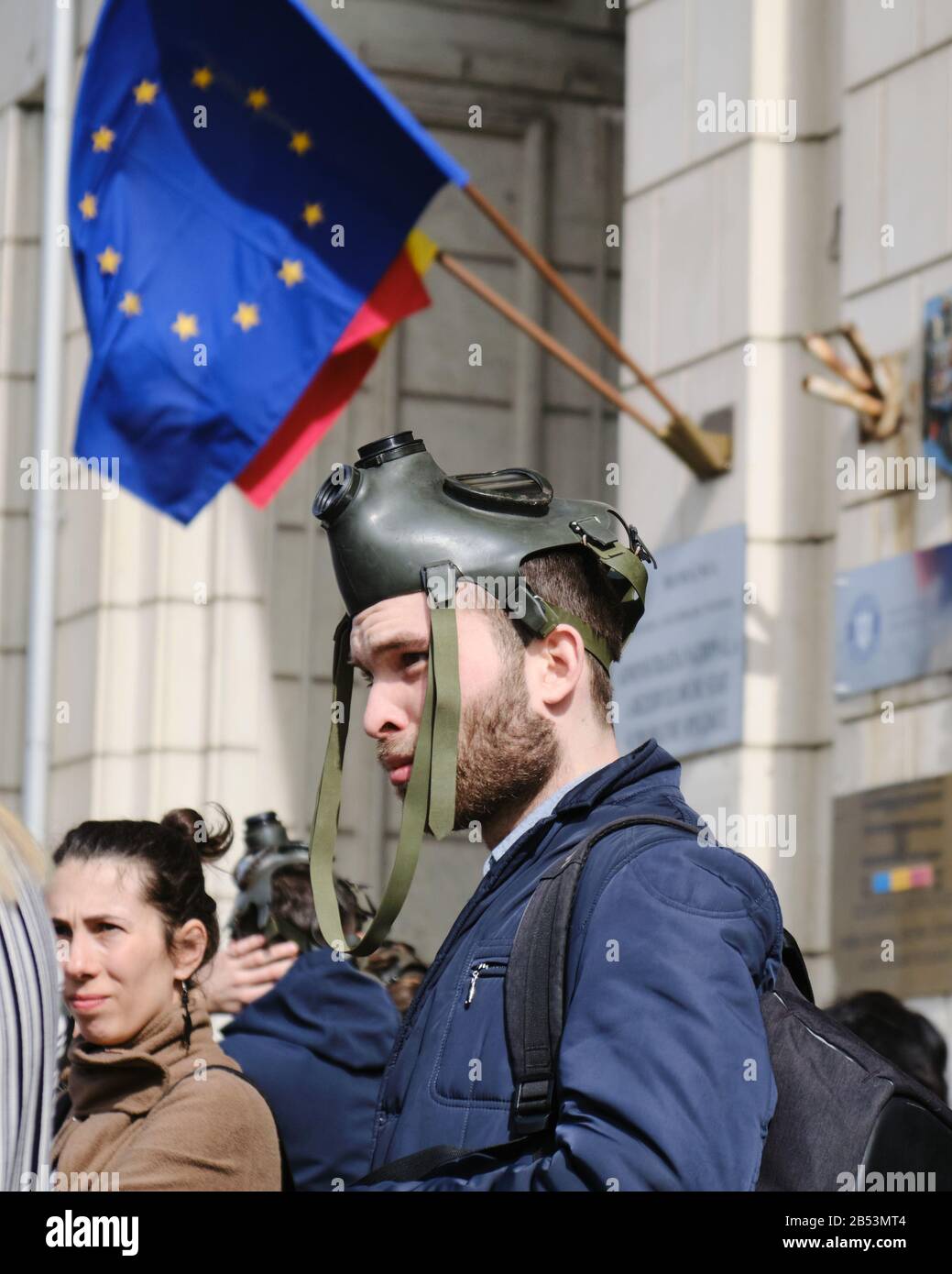 Bucharest, Romania March 4, 2020 Man wears a gas mask on his head in
