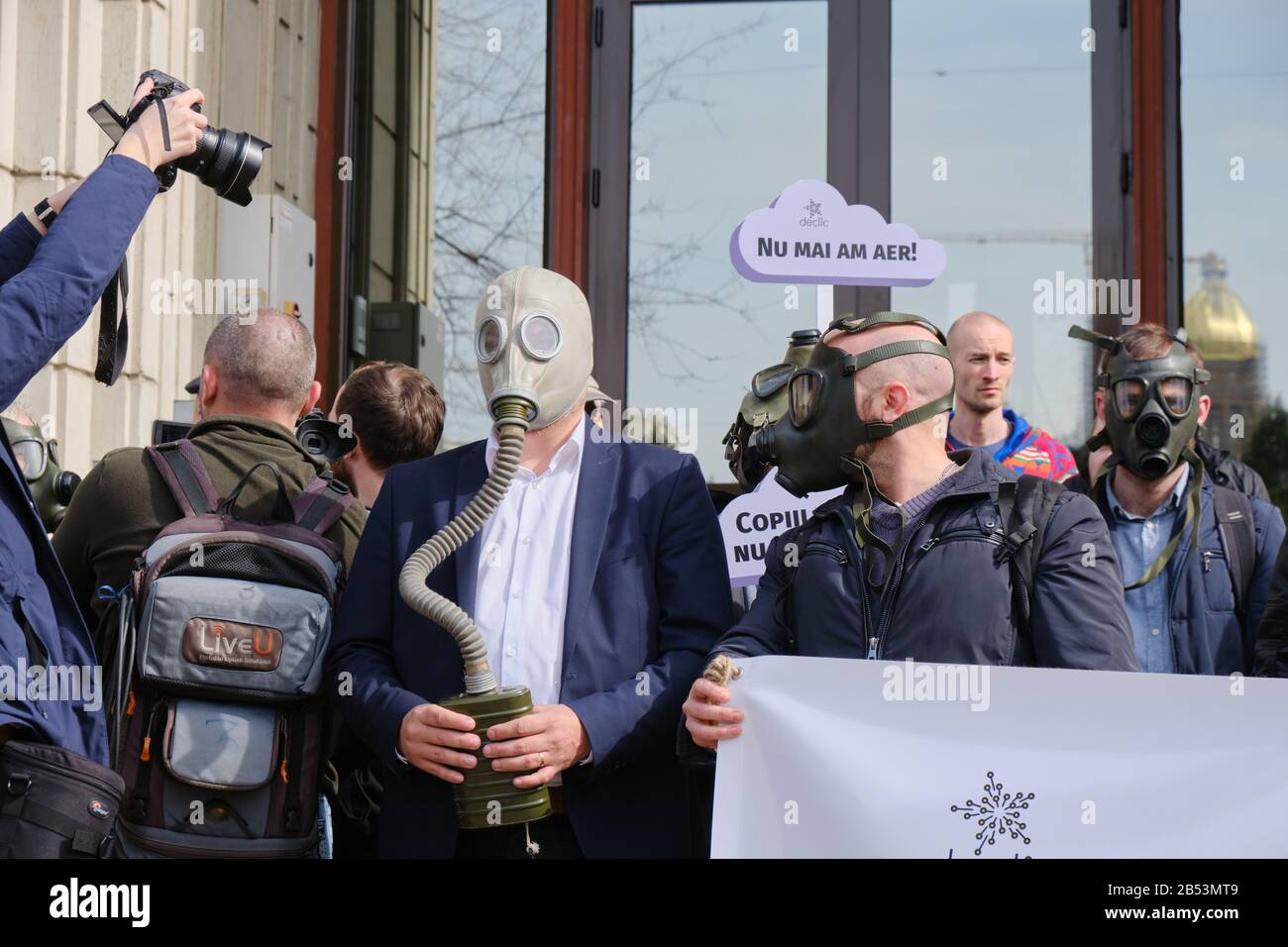 Bucharest, Romania - March 4, 2020: Protesters wear gas masks in response to extreme air pollution, during a protest in front of the Ministry of Envir Stock Photo