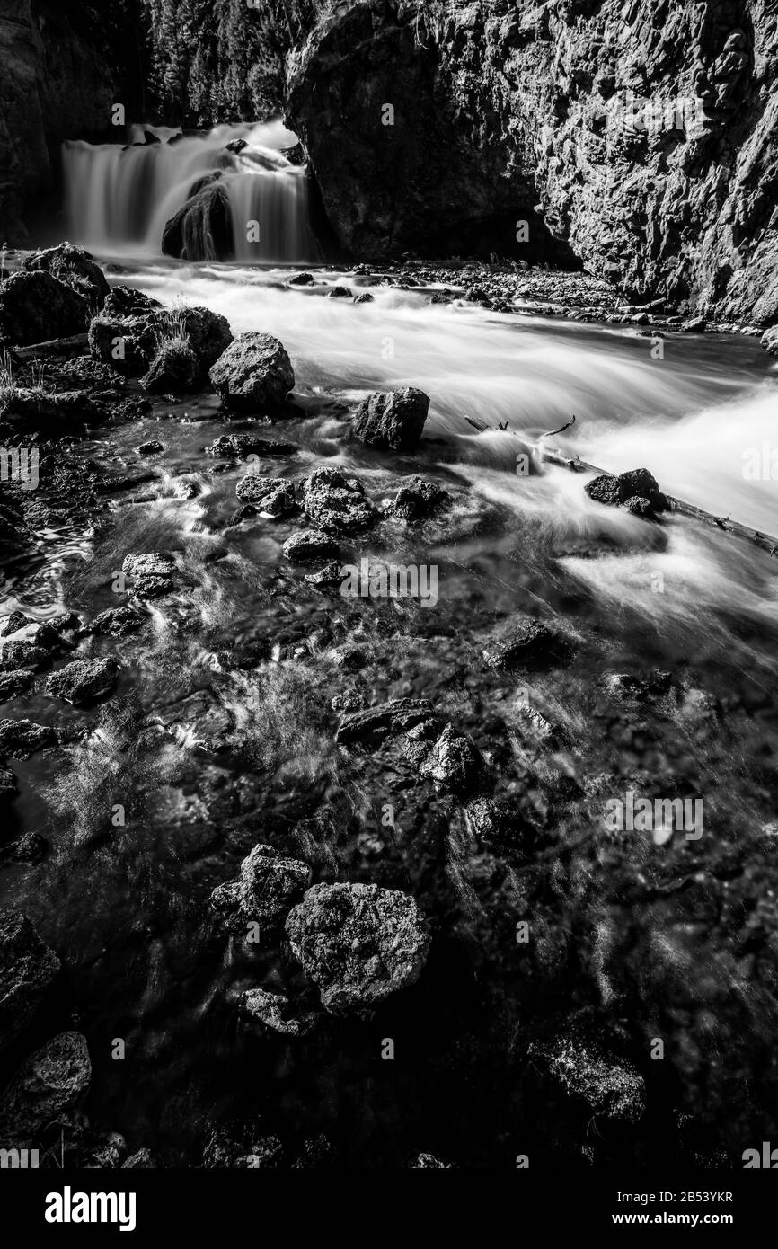 Black and white waterfall in Yellowstone National Park along the Firehole River Stock Photo