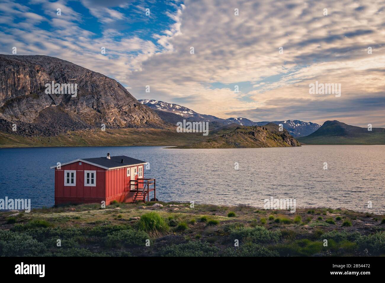 Red shelter on a lakeside on the Arctic Circle Trail, Greenland --- NIKON D7500 & 17.0-70.0 mm f/2.8-4.0: 17 m Stock Photo