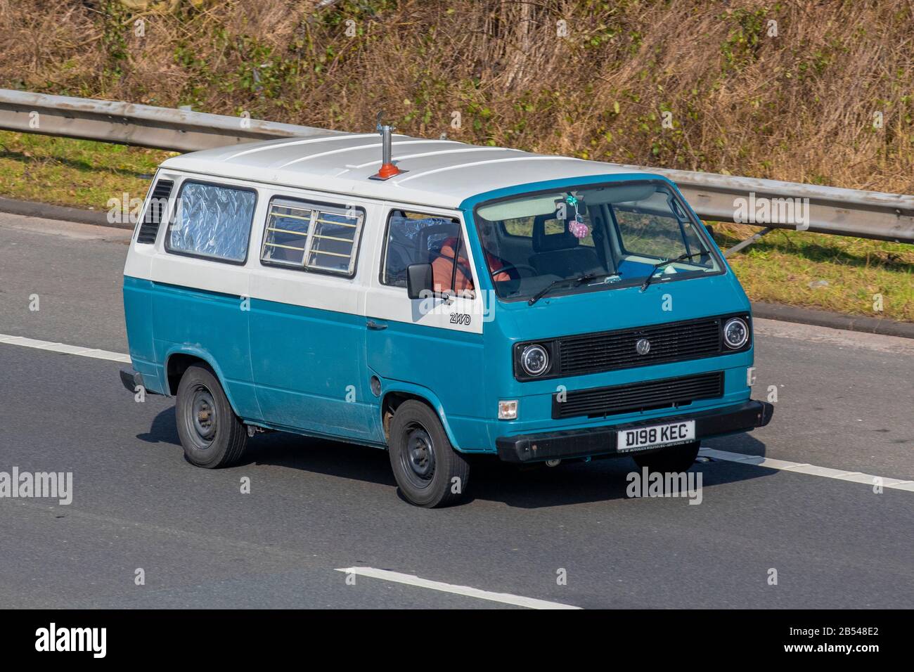 1987 80s blue white VW Volkswagen campervan; Touring Caravans and Motorhomes, campervans on Britain's roads, RV leisure vehicle, family holidays, caravanette vacations, caravan holiday, van conversions, autohome, life on the road, Stock Photo