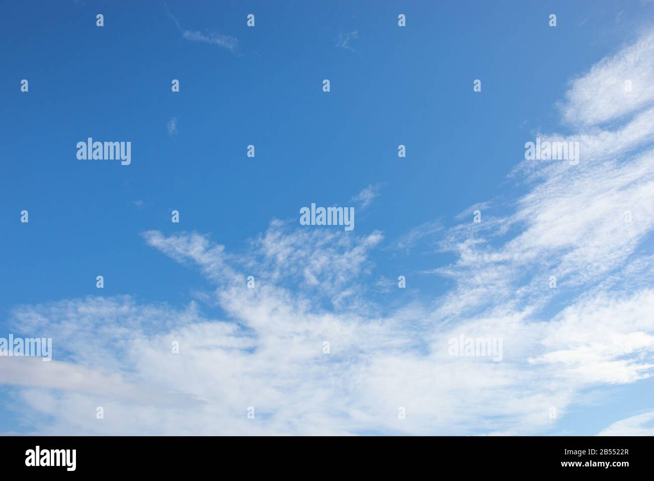 White fluffy clouds on bright blue sky Stock Photo - Alamy