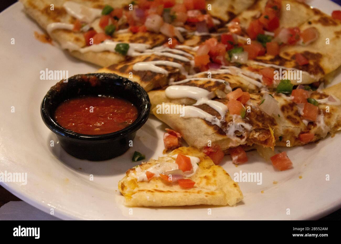on a plate is salsa for dipping delicious quesadilla with vegetables Stock Photo
