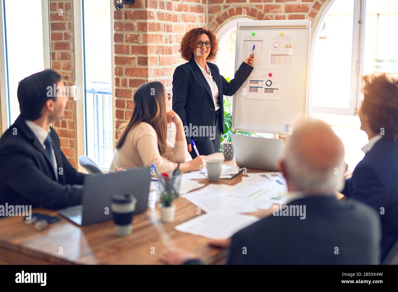 Group of business workers smiling happy and confident in a meeting