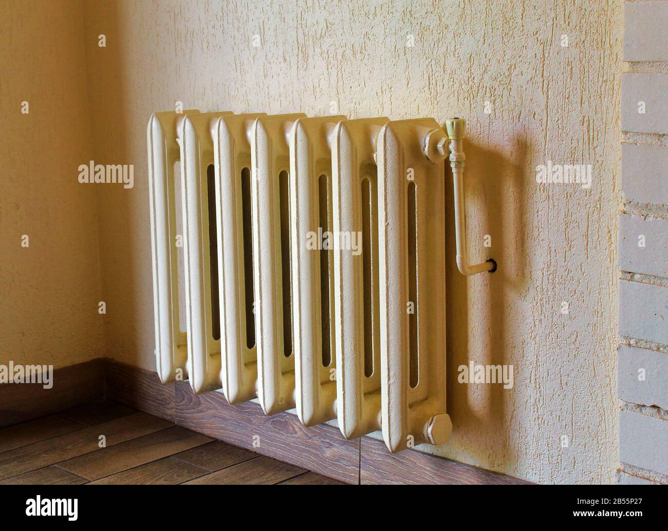 Cast iron radiator vintage on wall Stock Photo - Alamy