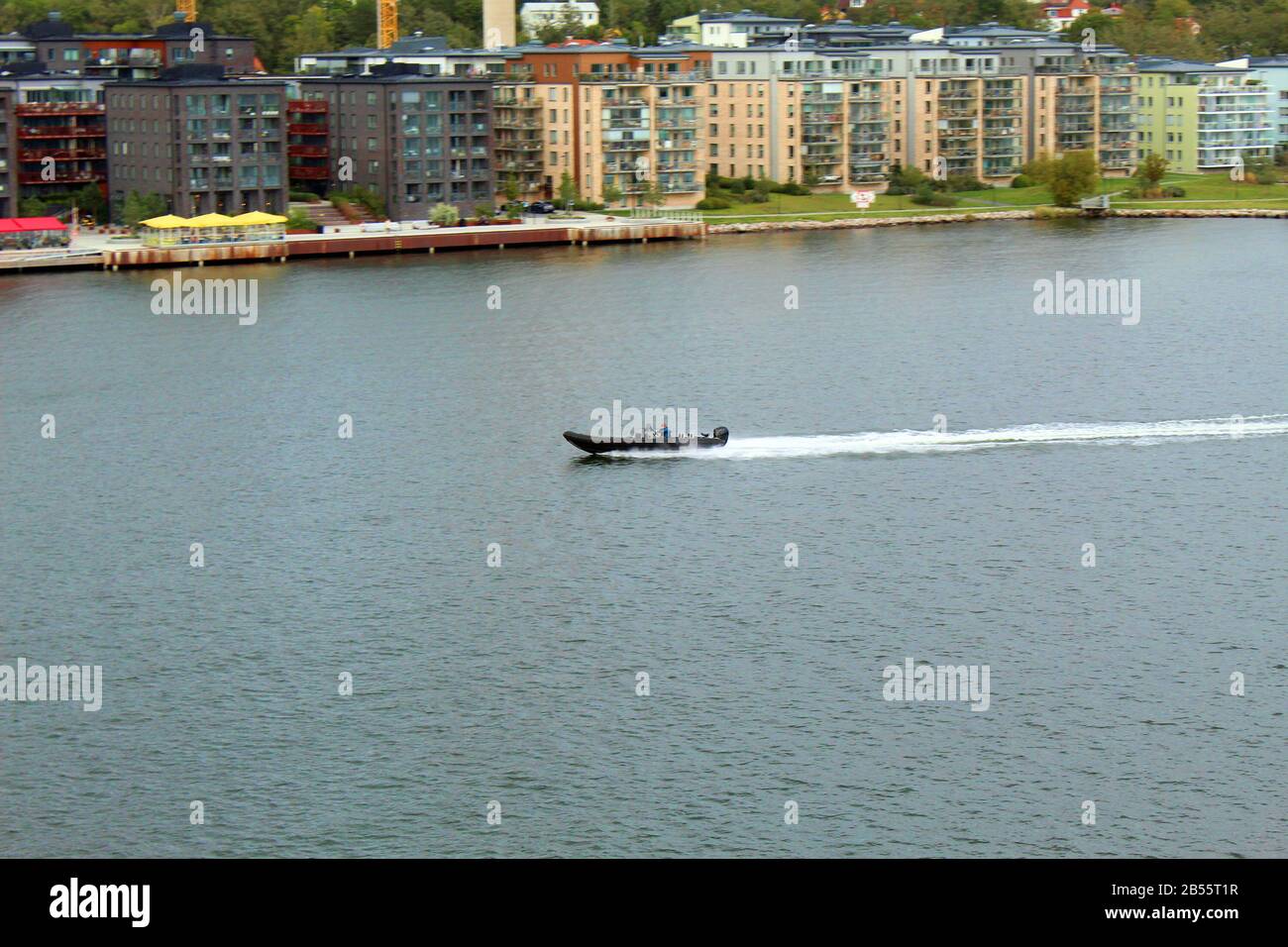 Man driving a fast boat with motion blue background Stock Photo - Alamy
