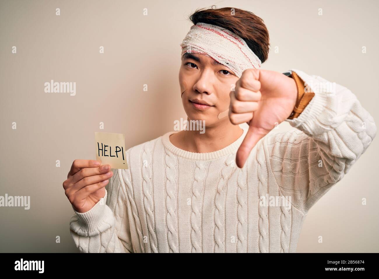 Young handsome chinese man injured for accident wearing bandage on head ...