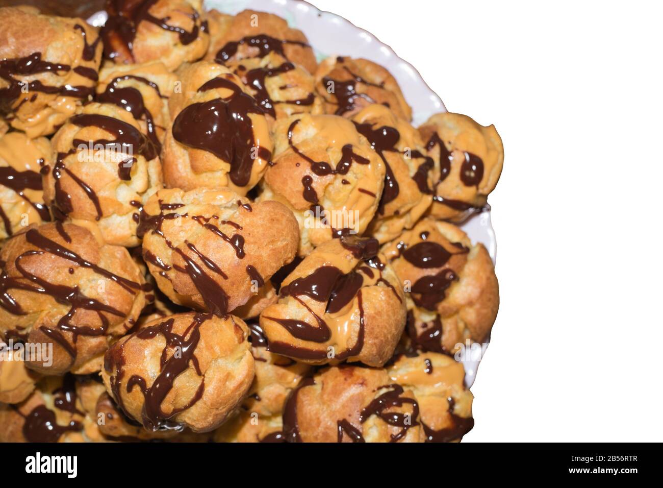 Chocolate poured eclairs isolated on white background. Stock Photo