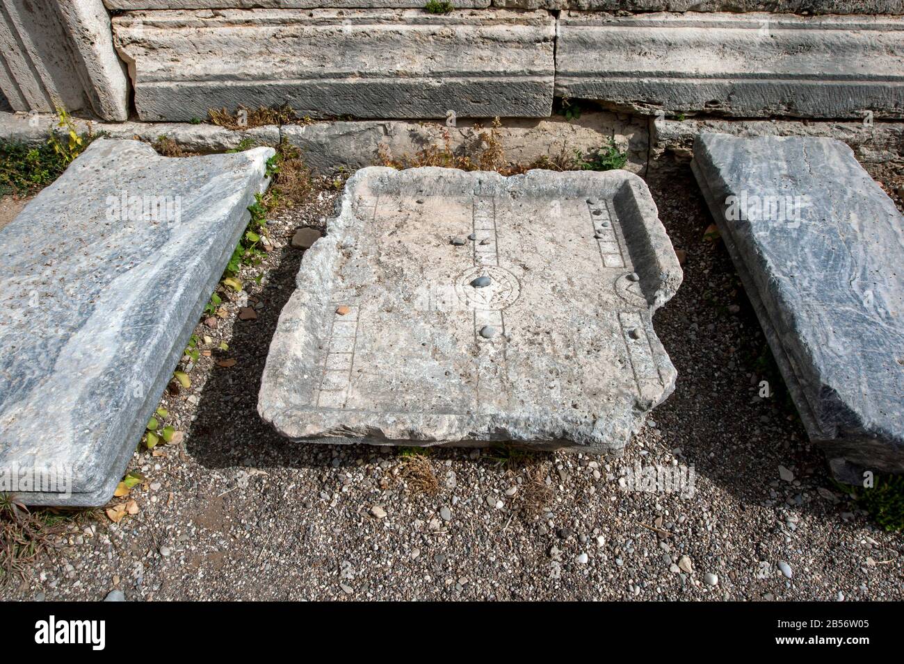 The remains of an ancient game carved into stone which includes squares ...