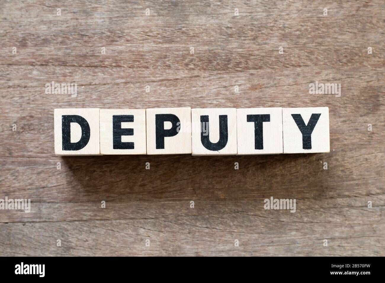 Letter block in word deputy on wood background Stock Photo