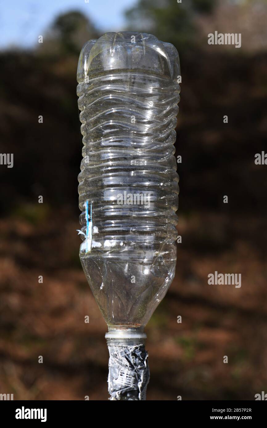 Old plastic water bottle taped to a pole Stock Photo Alamy