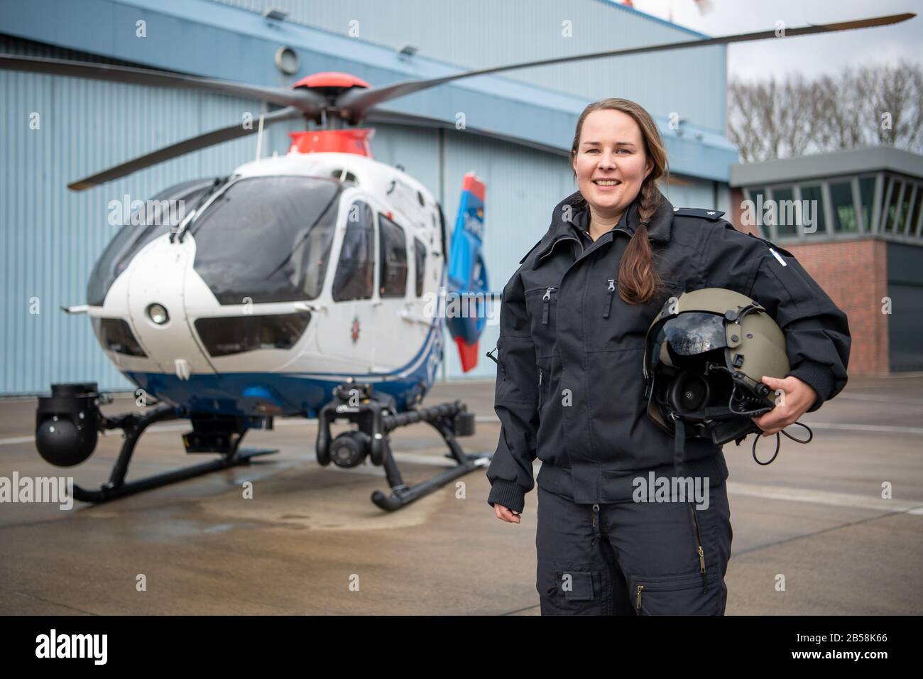 Rastede, Germany. 04th Mar, 2020. Kirsten Böning, helicopter pilot, is standing in front of the police helicopter model EC 135. Böning is the first police helicopter pilot in Lower Saxony, after a good year in service she takes stock. Credit: Sina Schuldt/dpa/Alamy Live News Stock Photo