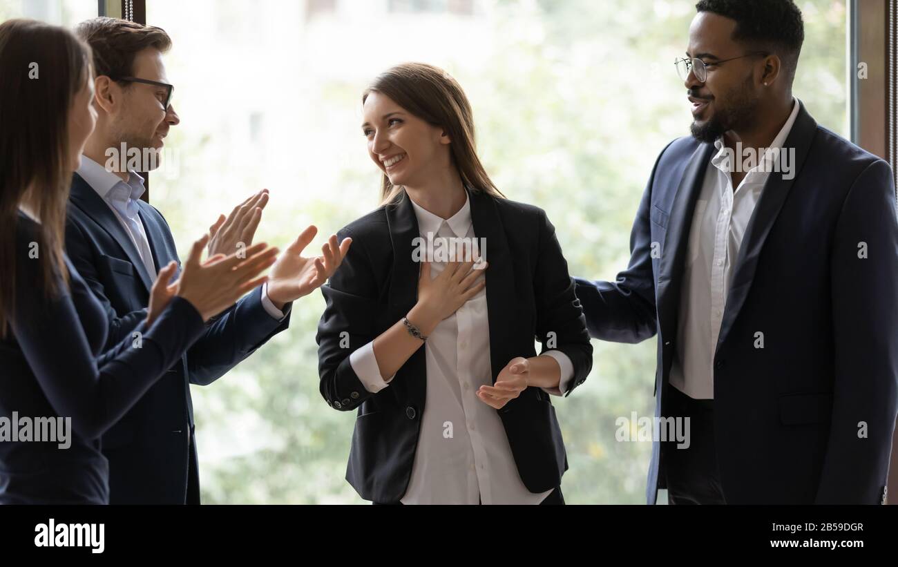 Diverse businesspeople applaud greeting with success colleague Stock Photo