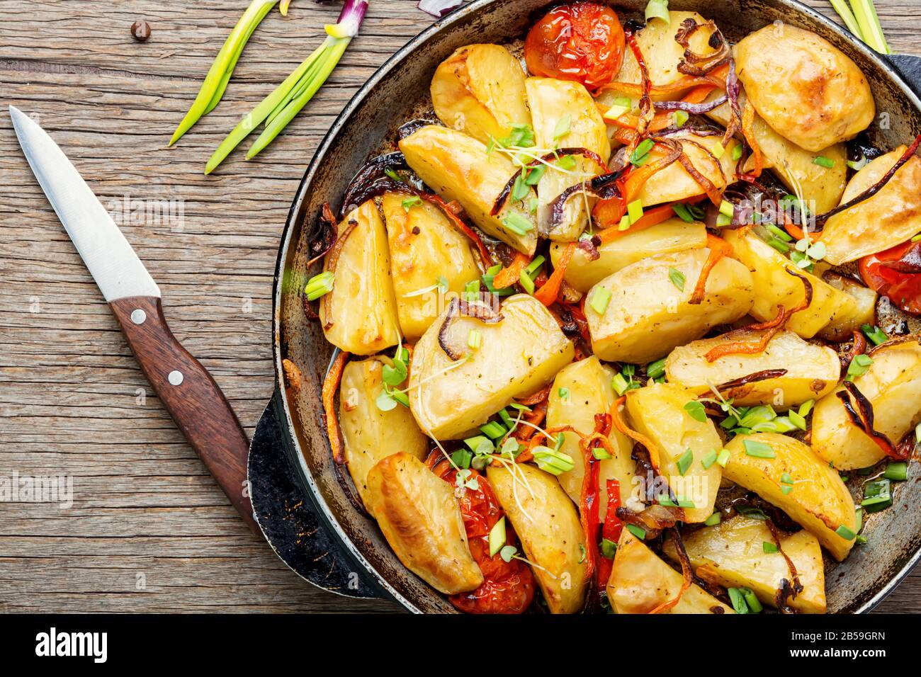 Fried potato with tomato and onion.Baked fried potatoes Stock Photo - Alamy