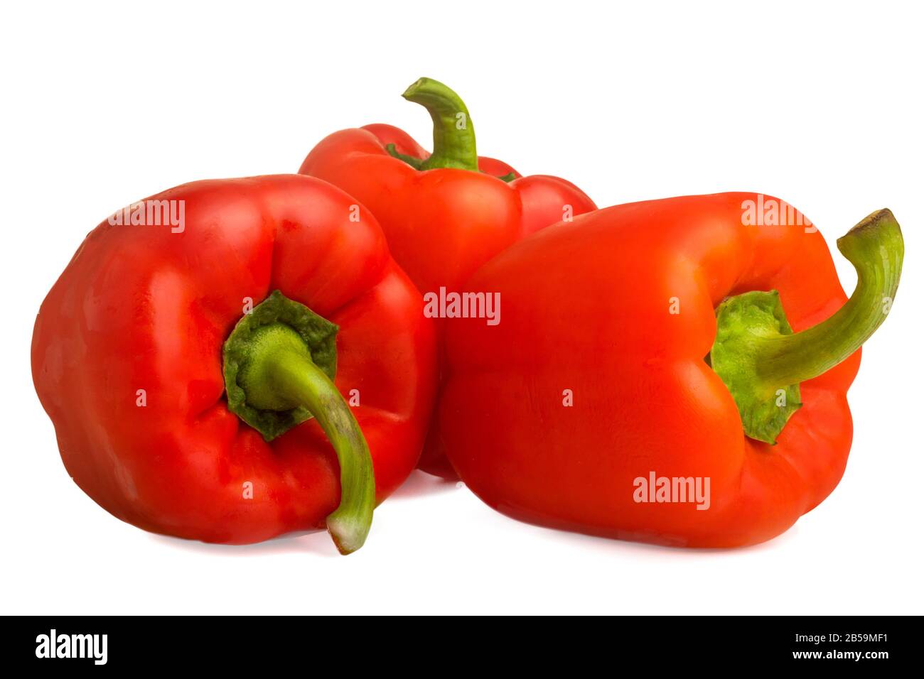 image of three red bell peppers on a white background Stock Photo