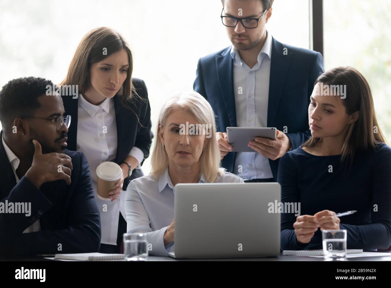 Diverse businesspeople brainstorm work together at laptop Stock Photo