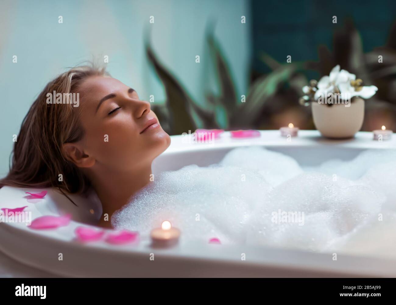 Woman lying in bath tub hi-res stock photography and images - Alamy