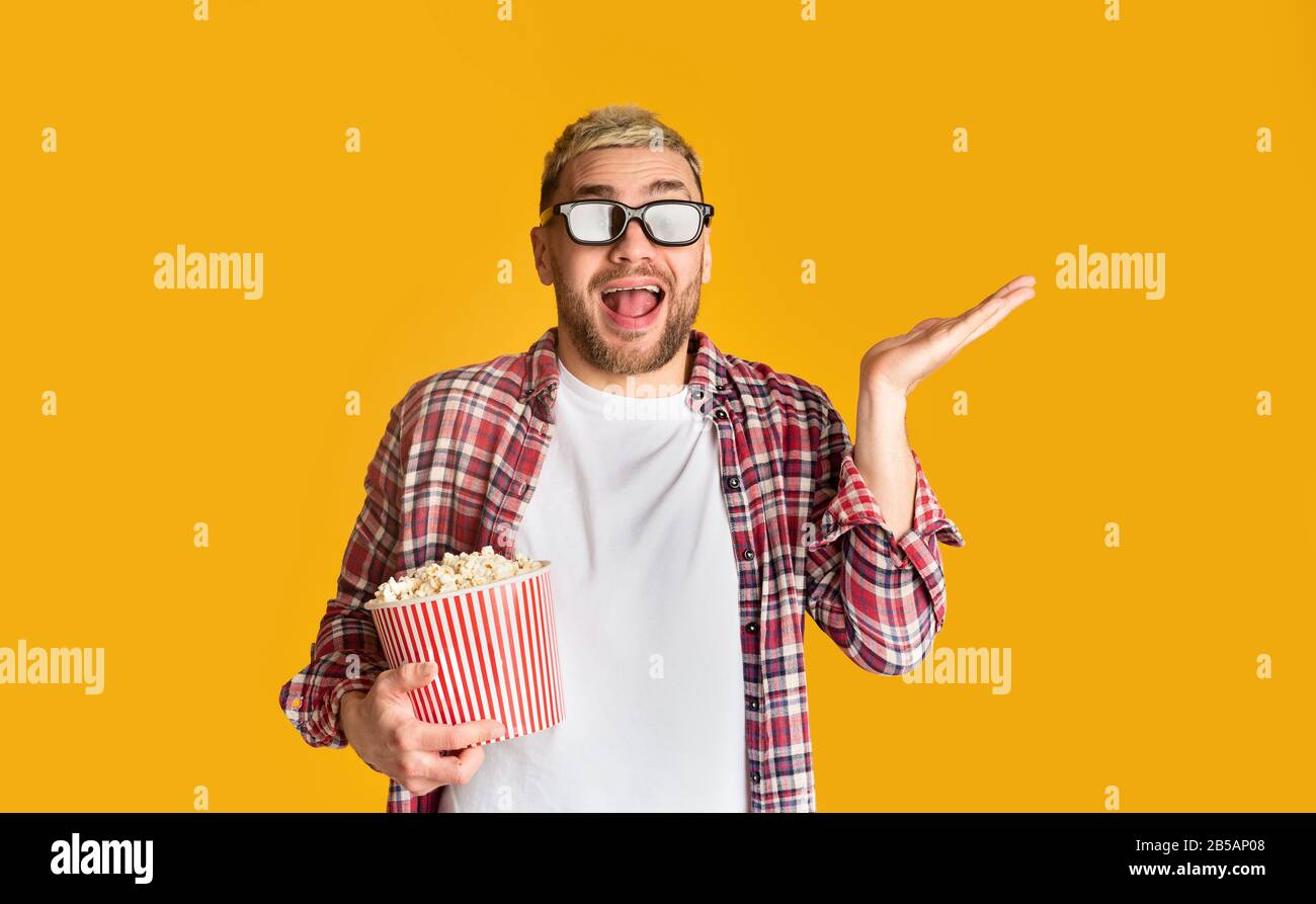 Funny man in glasses and popcorn ready to watch movie Stock Photo