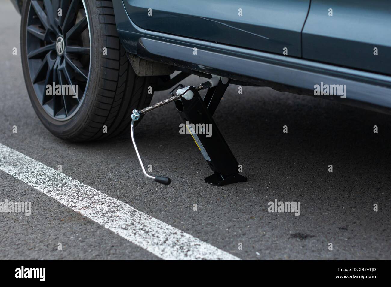 Jack is lifting up a vehicle. Automobile service. Tire replacement concept, Prague, March, 2020. Stock Photo