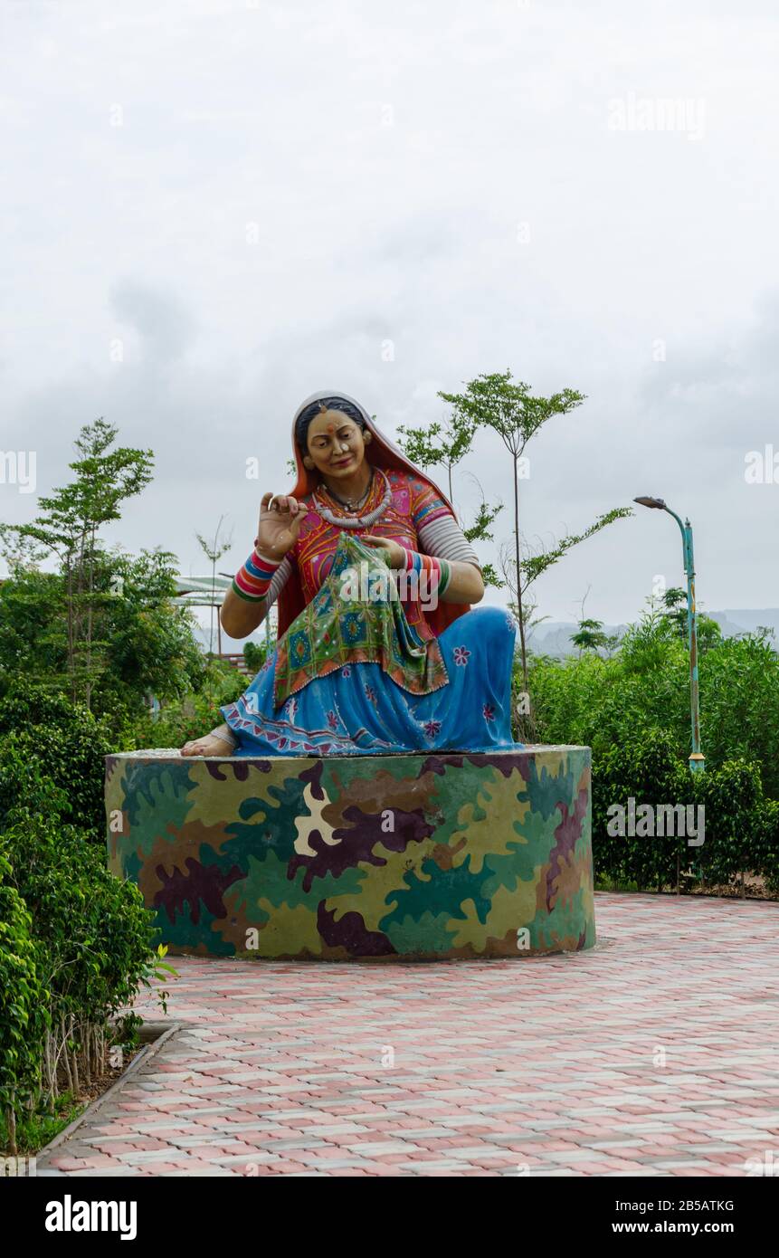 Full length statue of a Gujarati woman weaving Kutch embroidery work